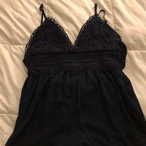 Navy blue romper with adjustable straps and a tie in the back